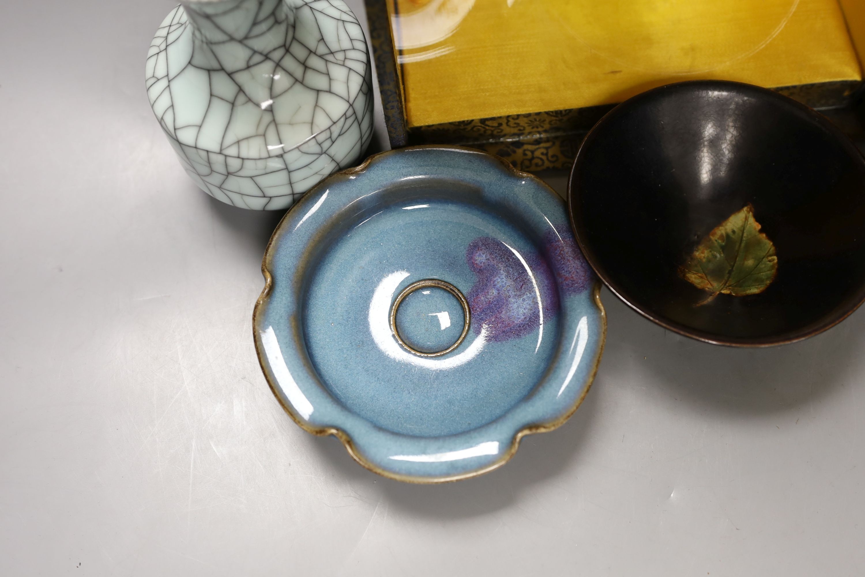 A group of Chinese monochrome ceramics, comprising two crackle glaze vases, tallest 21 cm, one cased, a Jun type dish and tripod censer a leaf impressed bowl and another bowl